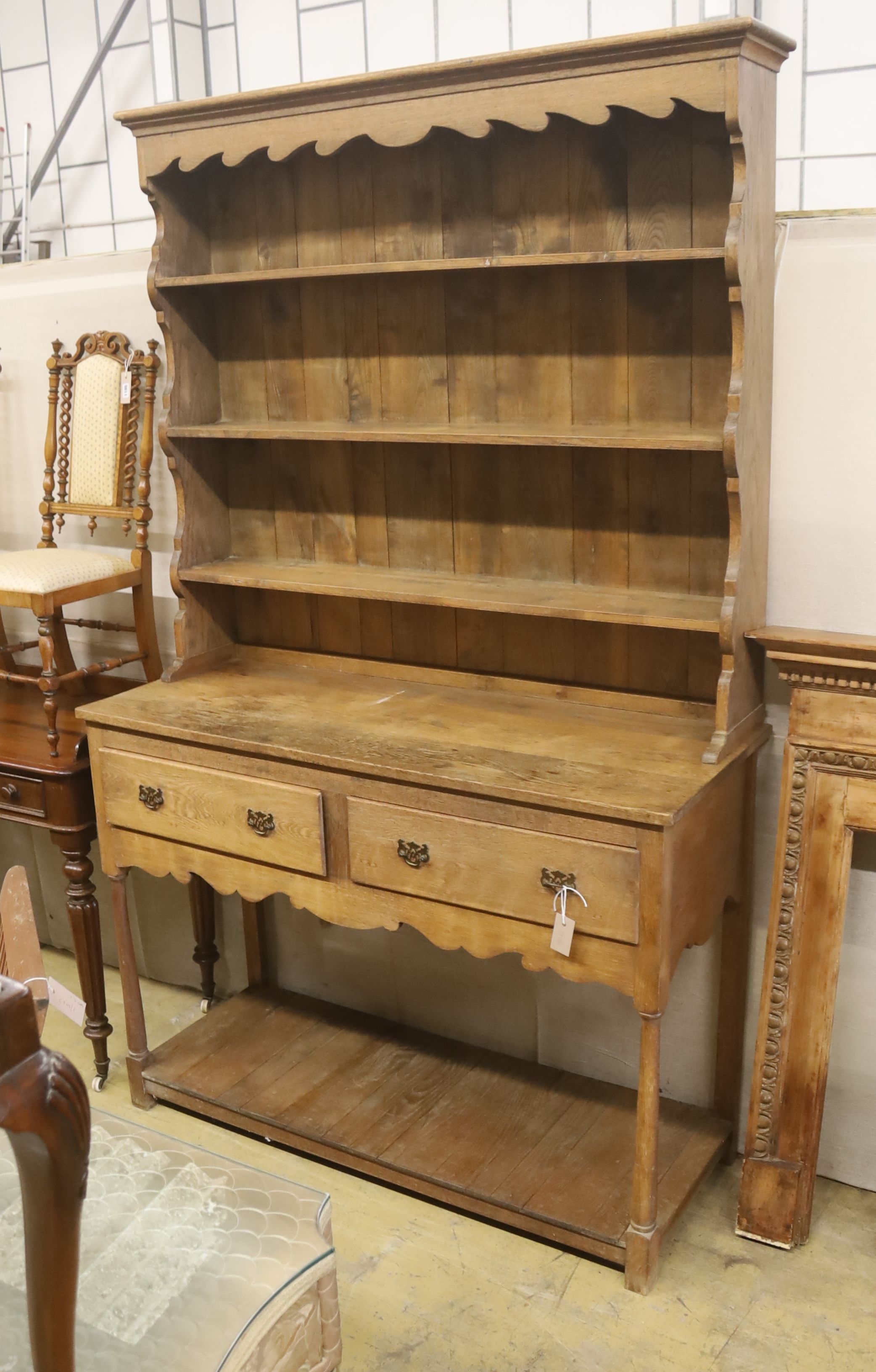 An early 20th century oak potboard dresser, length 126cm, depth 50cm, height 206cm